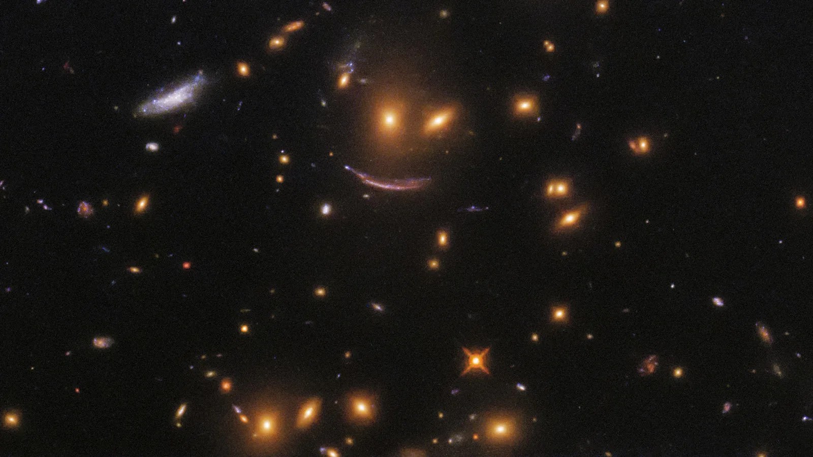 Collection of multiple galaxies, including three that form a traditional smiley face shape.