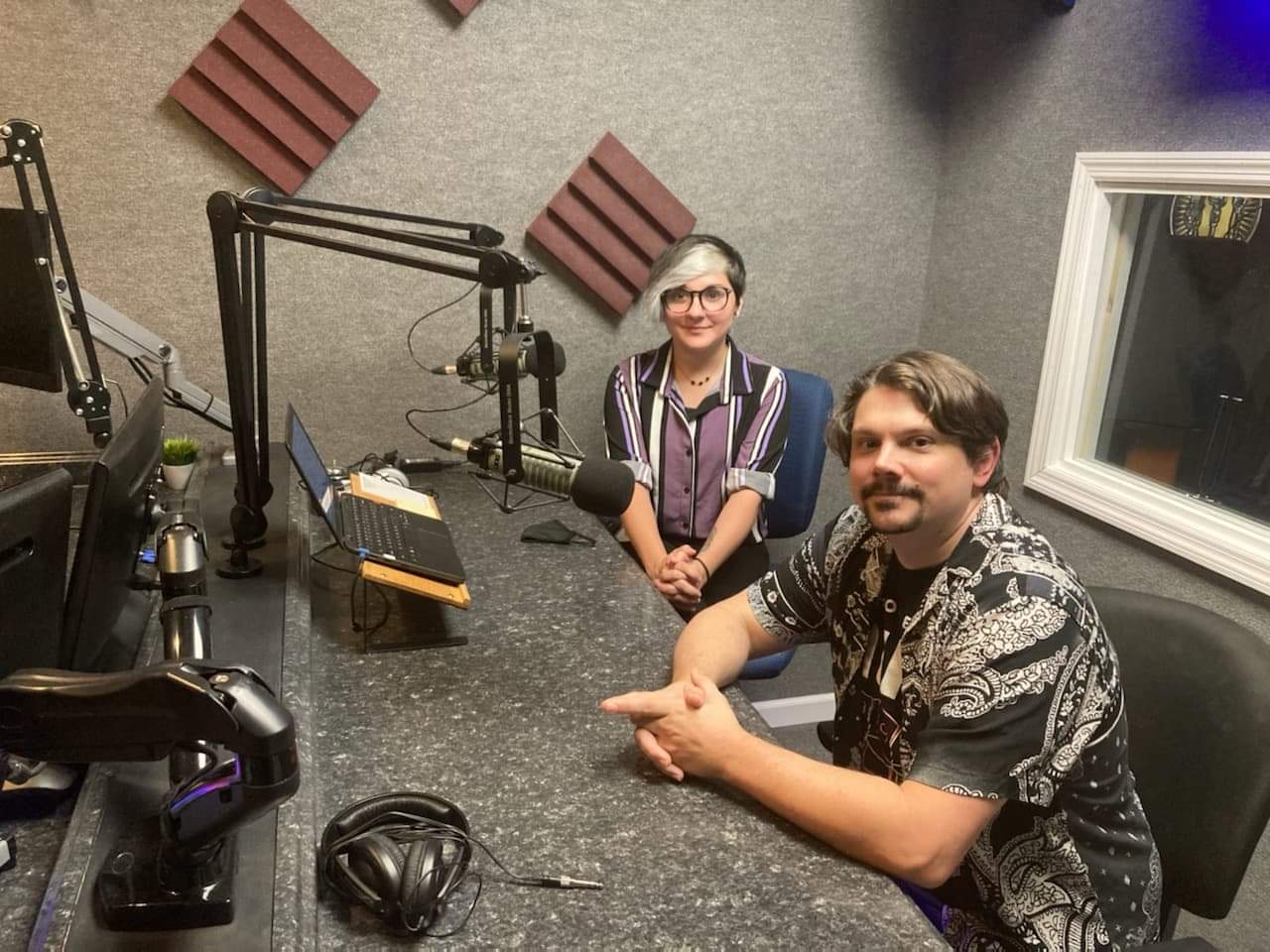 Alex Lewis and Matt Cass pose in a radio booth after an interview about JWST.