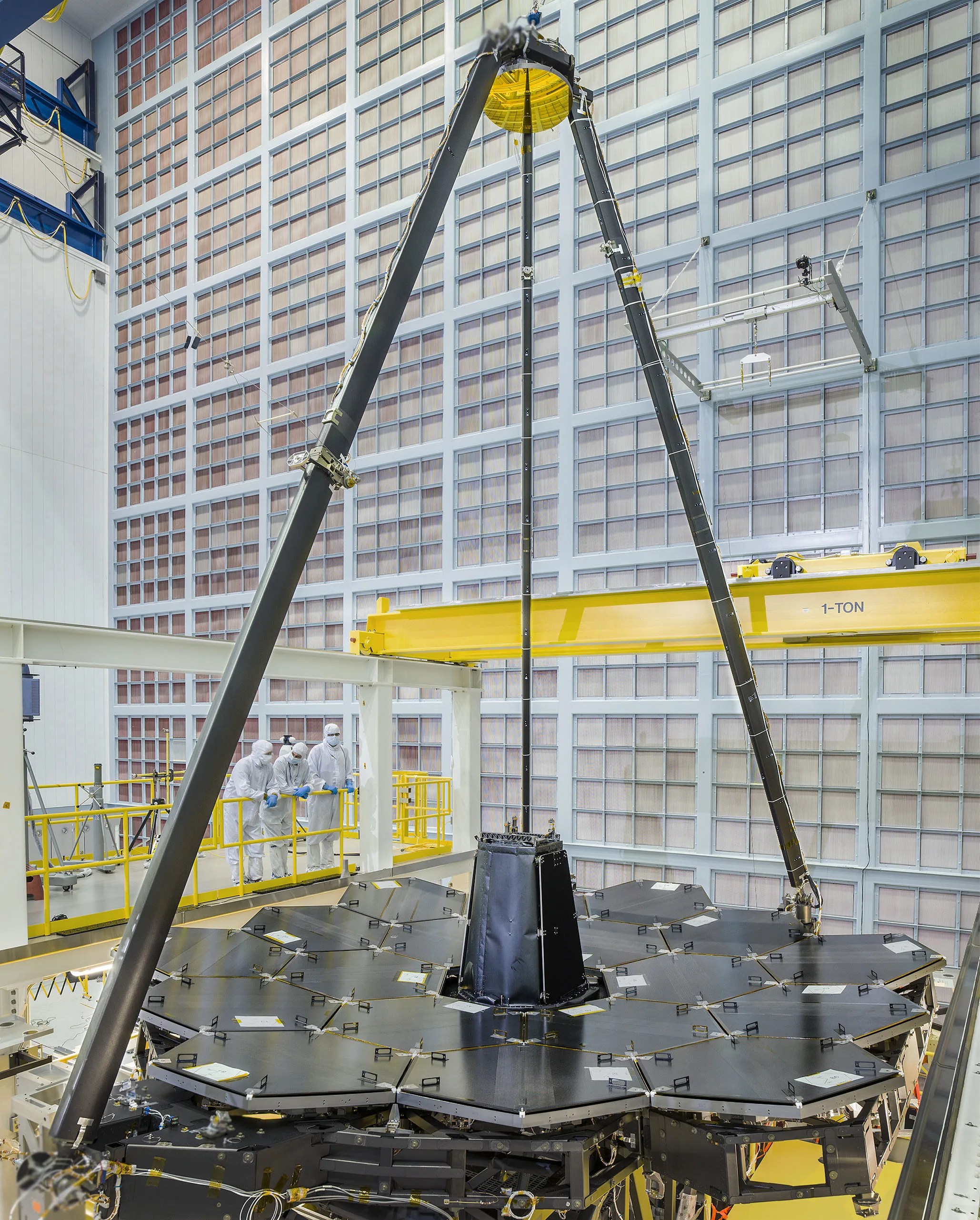 This photo shows the first time that the optically complete telescope (18 primary mirror segments, the secondary mirror, and the Aft Optics Subsystem which contains the tertiary mirror) was placed in a deployed configuration.