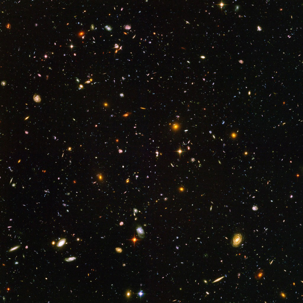 10,000 galaxies in a single image, appearing as small swirls and dots of light.