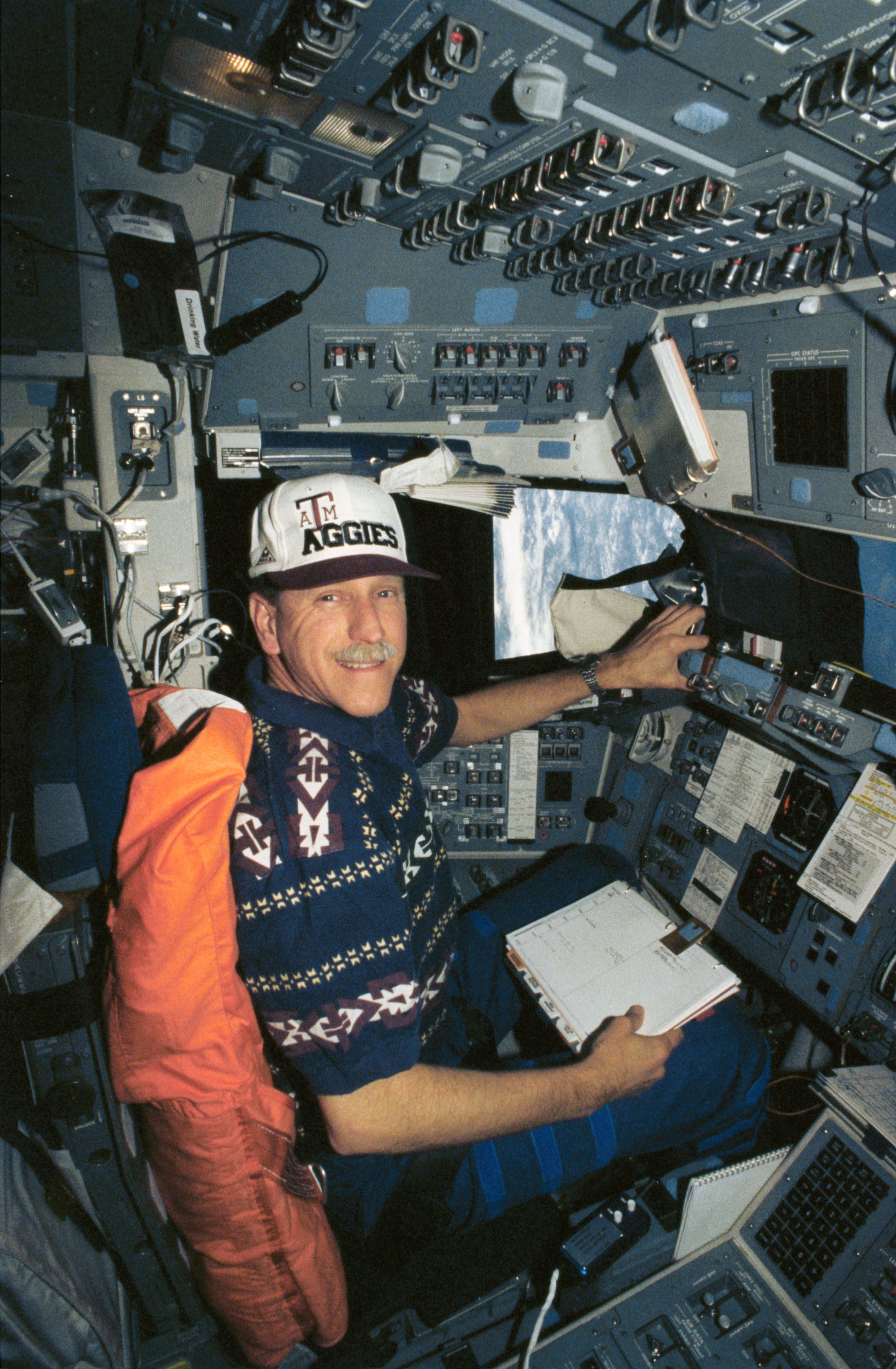 An astronaut at the commander station in the shuttle.