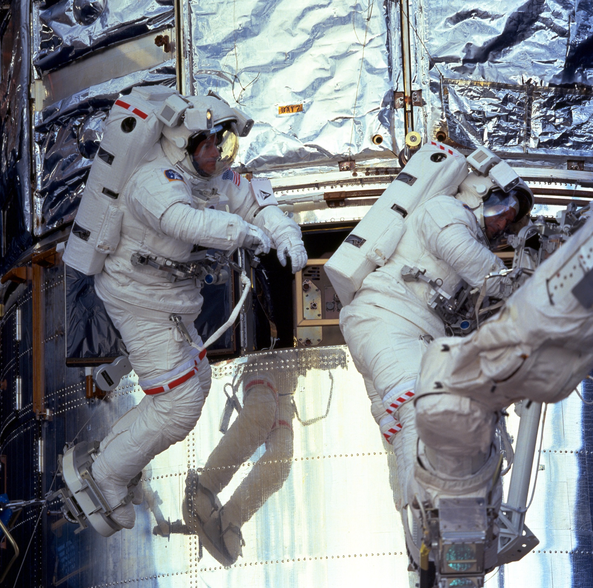 Two astronauts replacing hardware on the telescope.