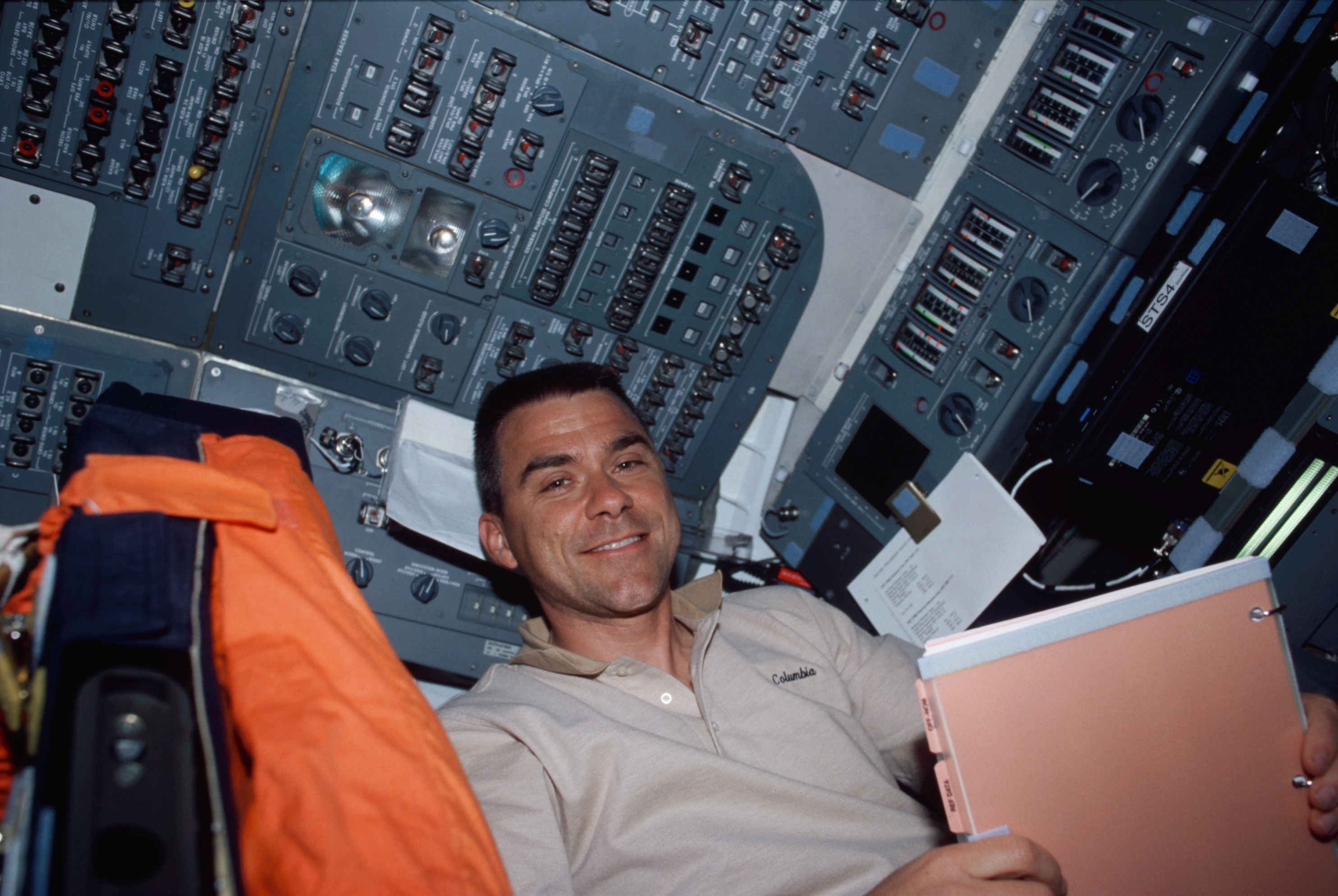 The pilot of the space shuttle poses for a photo while at the pilot's station.