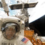 An astronaut poses for a picture through the back windows of the Space Shuttle.