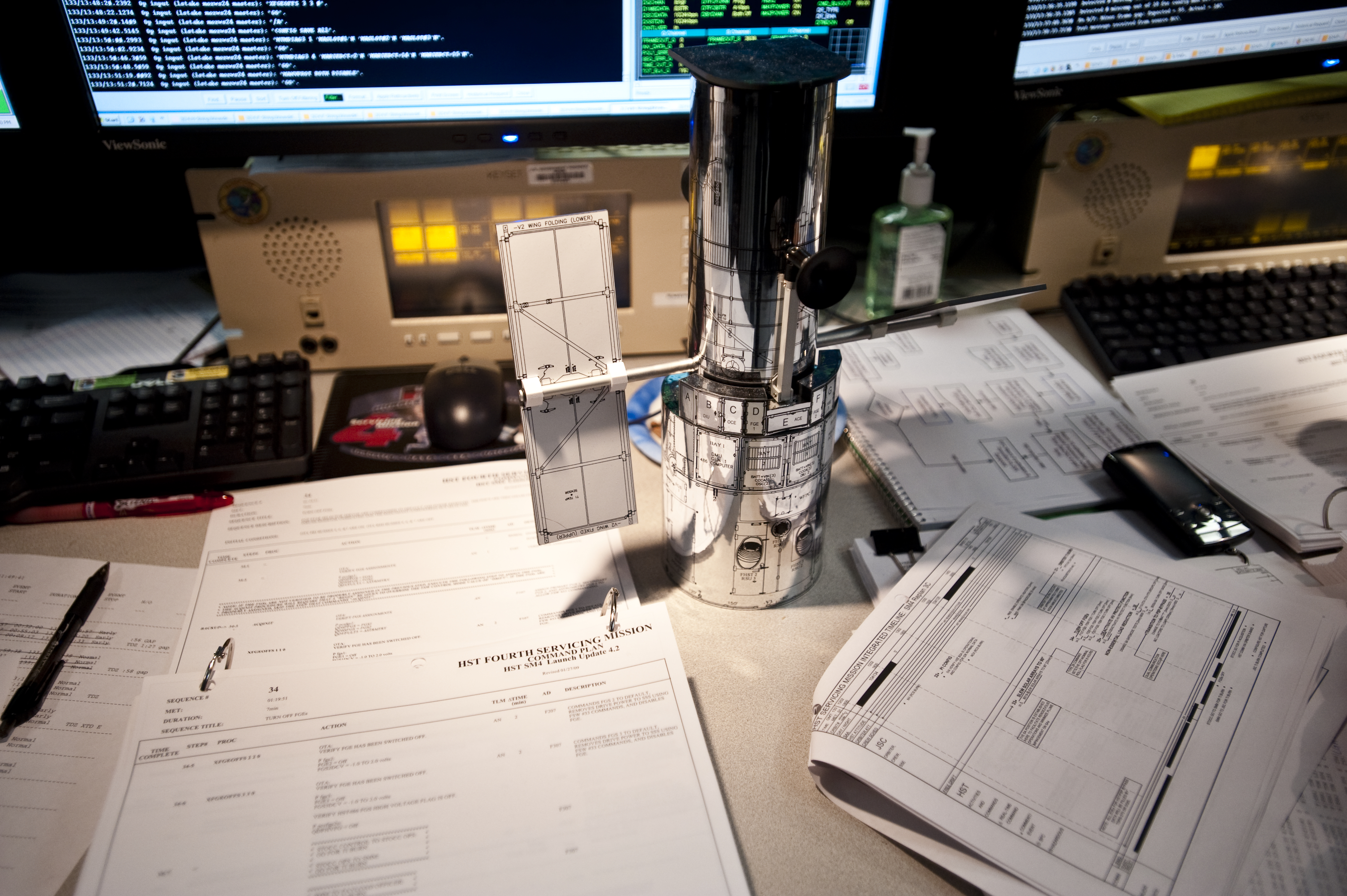 A Hubble model on a table at an engineers workstation in the control room.