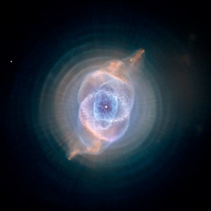 Purple and soft yellow dust and gas surrounding bright white star in the center of the image. Lots of bubbles of dust interweave each other.
