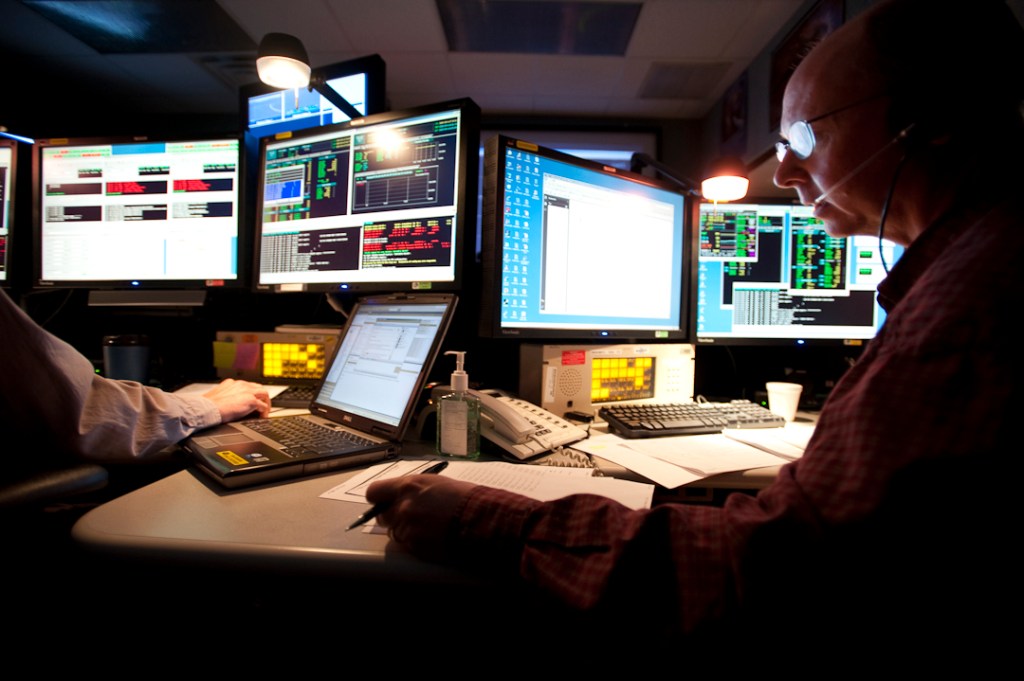 A flight operations lead checks off procedures in the control center.