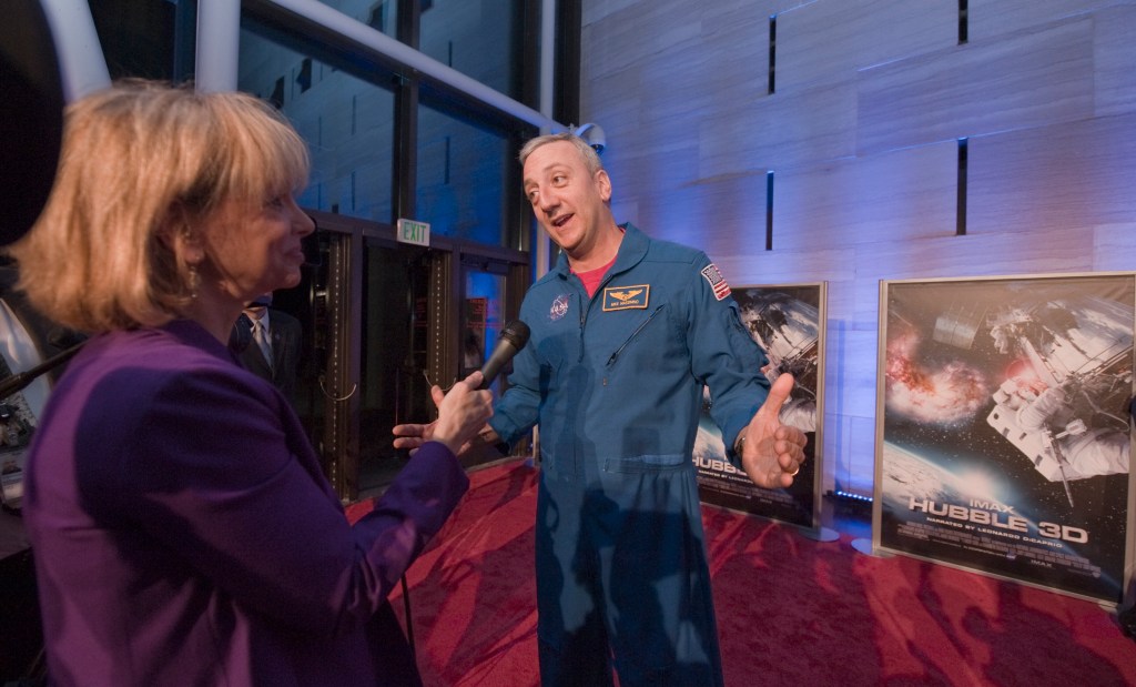 Astronaut Mike Massimino being interviewed by a reporter.