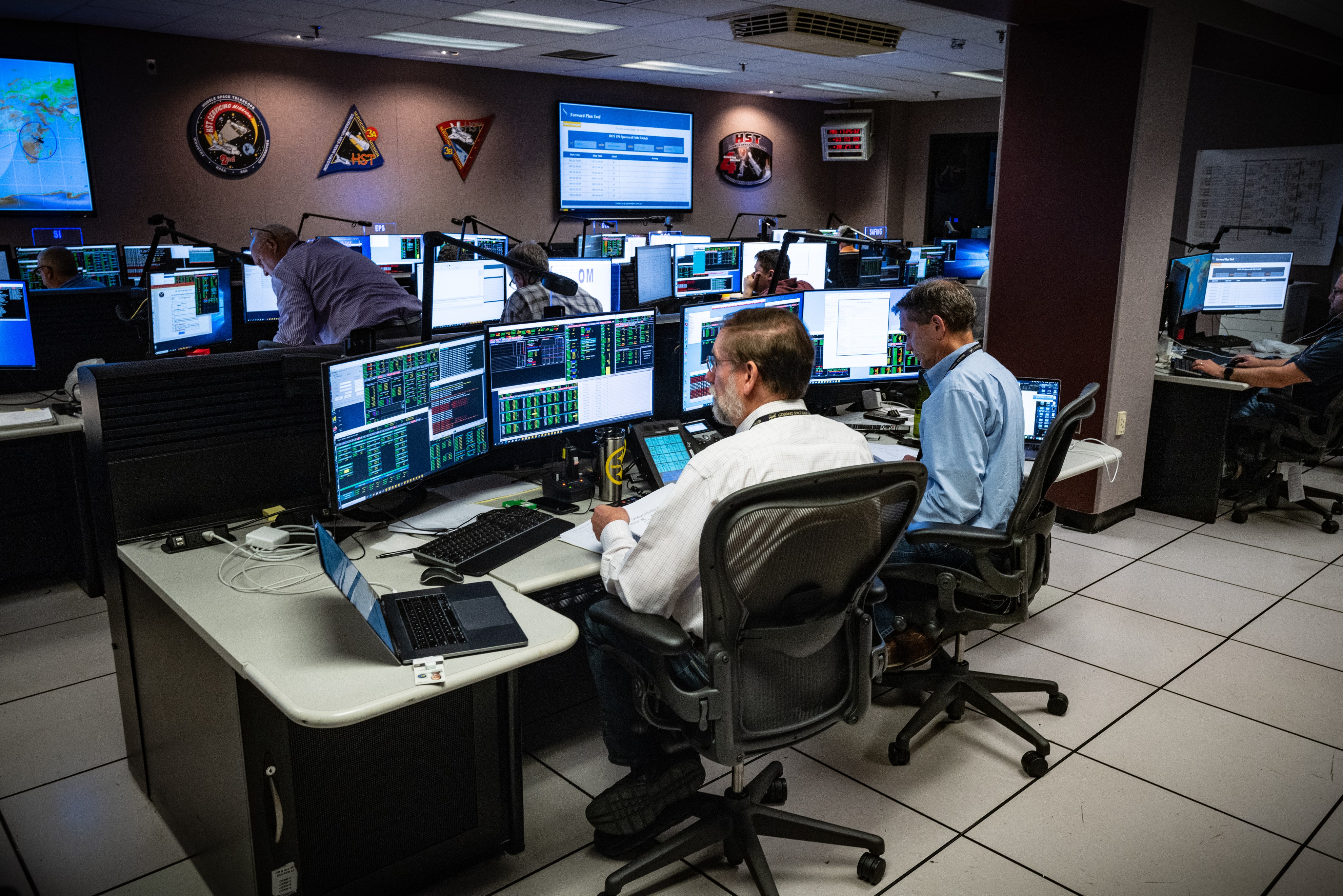 A operations room for Hubble with people looking at monitors.