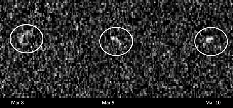 A grainy image with a distant asteroid circled