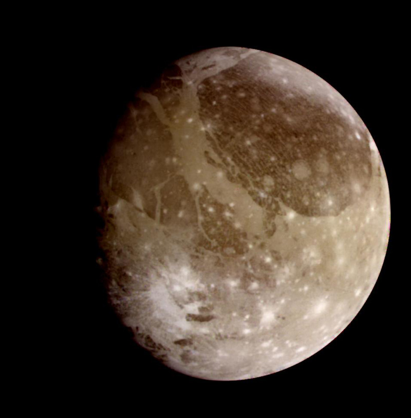 Full disk image of Ganymede, showing a brownish, heavily-craters surface.