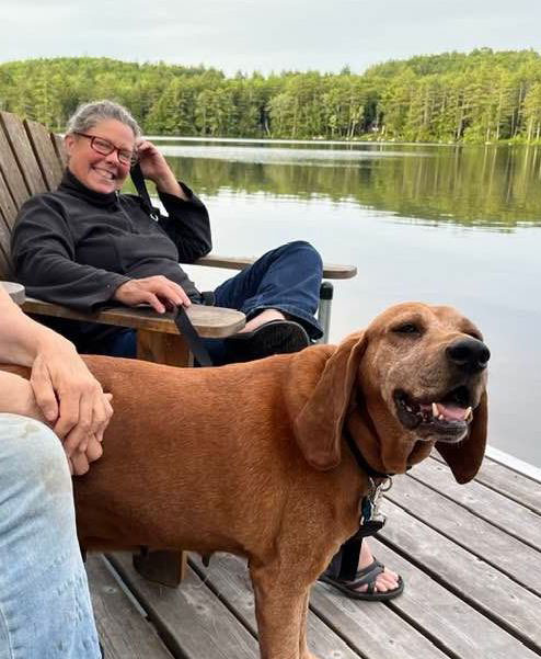 Leigh_Peake_and_a_big_dog_sitting_on_a_dock