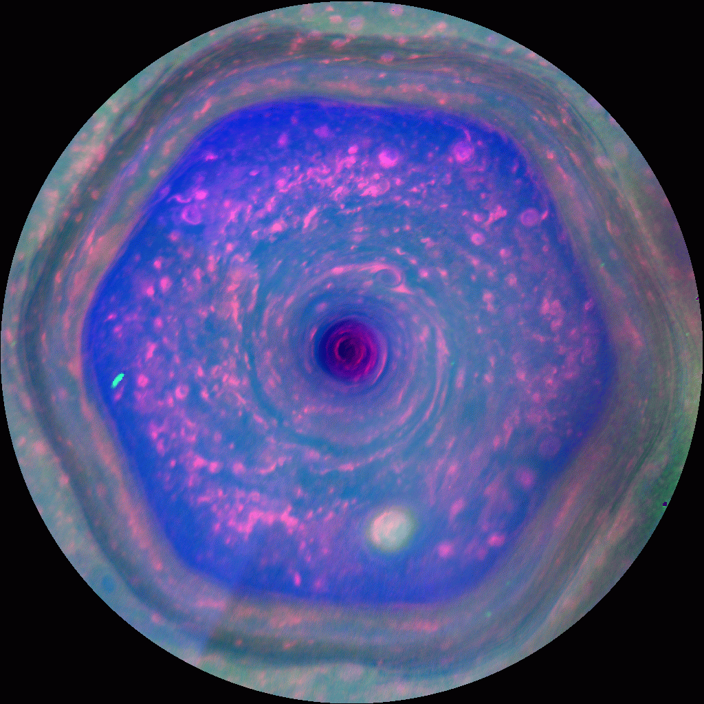 A color-enhanced image shows cloud patterns moving around a hexagon -shaped storm om Satirm.