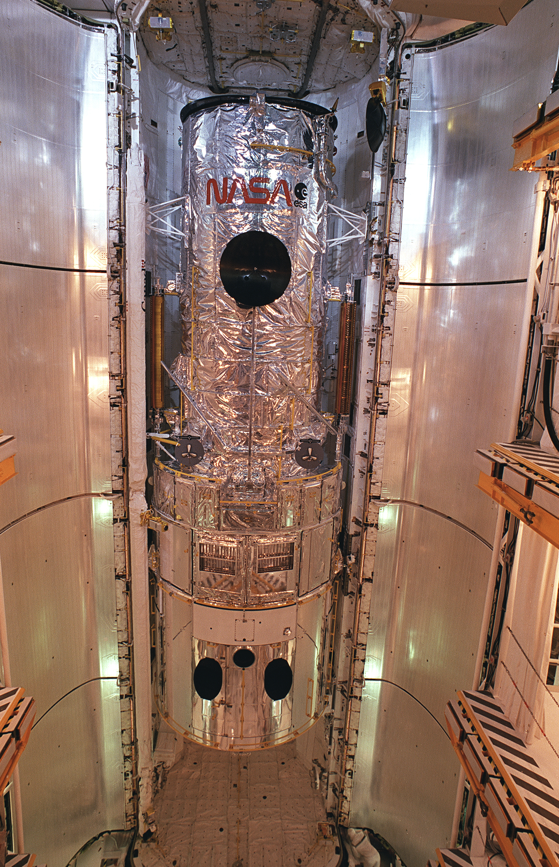 The Hubble telescope sits in the cargo bay of the shuttle.