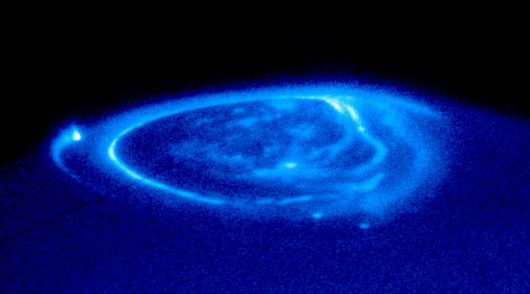 Blue glowing lines encircle one of the poles of Jupiter.