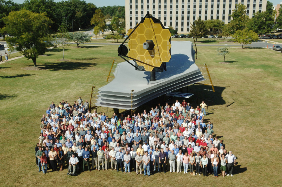 Some of the James Webb Space Telescope team are shown here in front of the Webb full-scale model at the Goddard Space Flight Center in Greenbelt, Maryland.