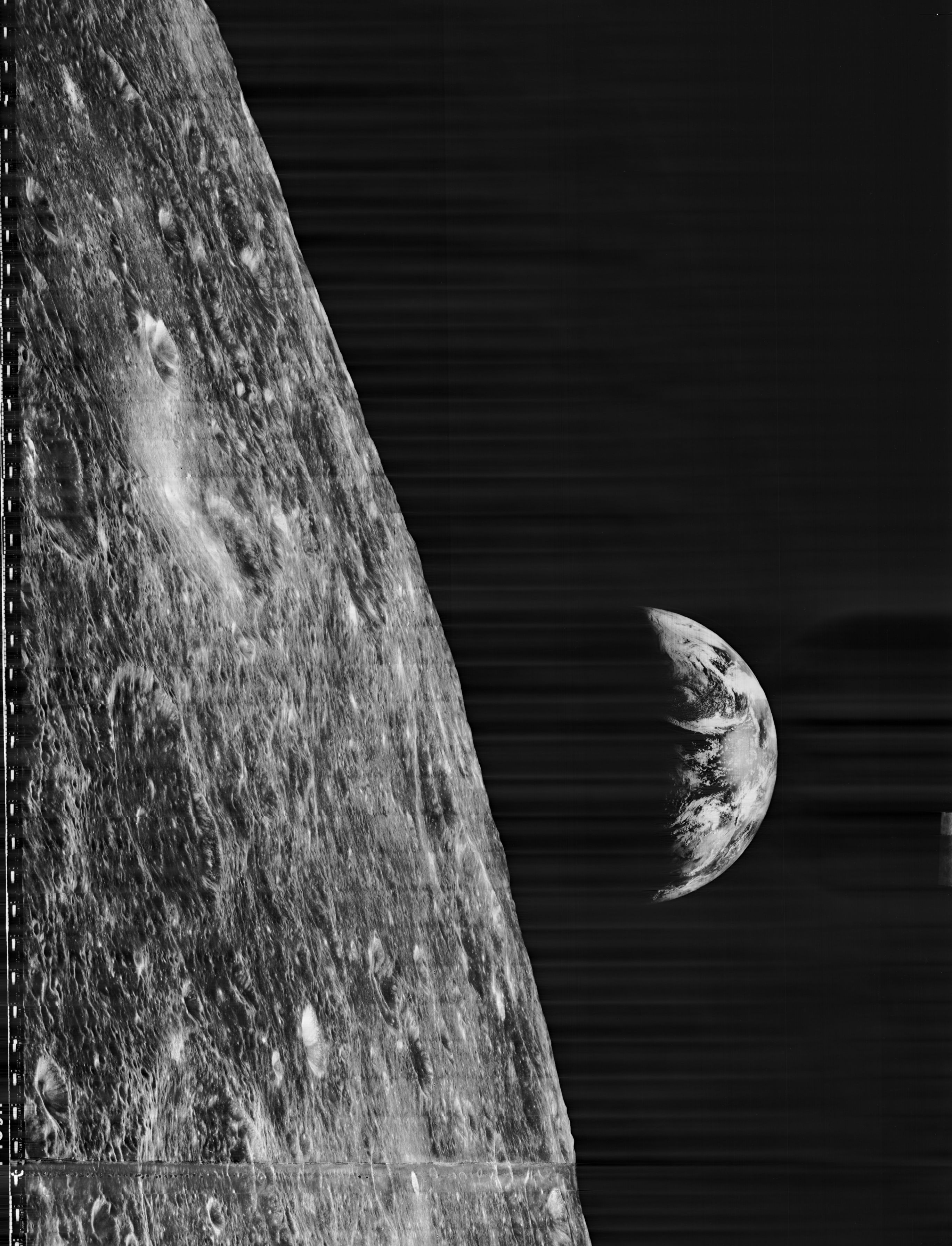 Left foreground: rugged, pockmarked lunar horizon. In the background, crescent Earth in a black sky. 
