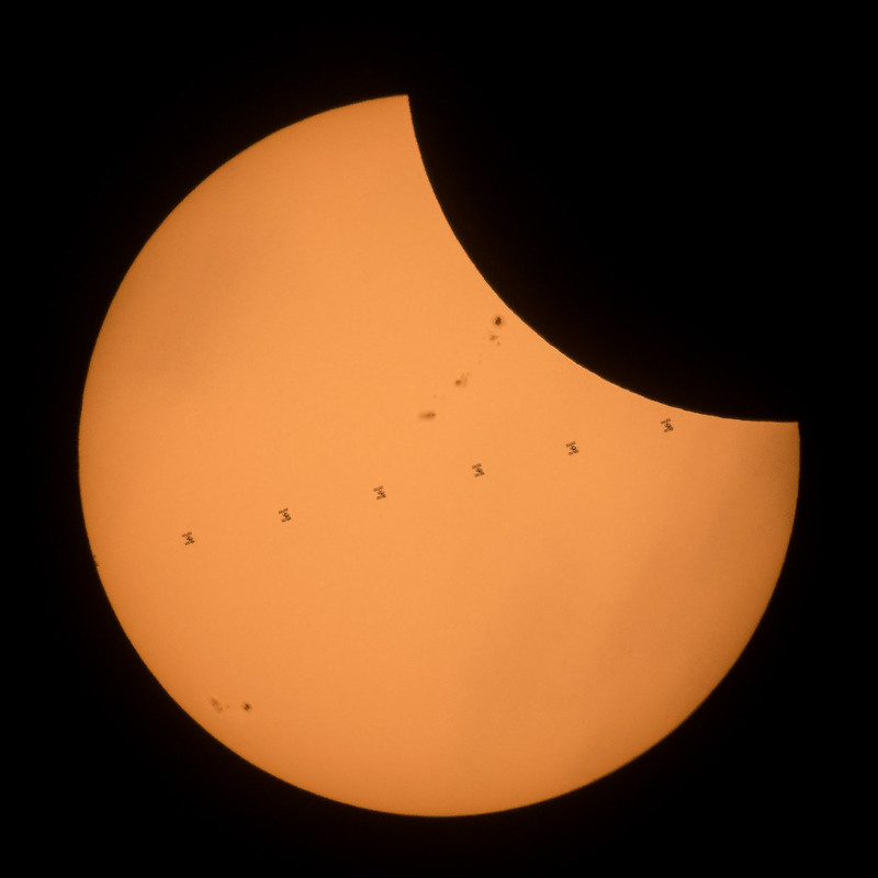 This composite image, made from seven frames, shows the International Space Station, with a crew of six onboard, as it transits the Sun at roughly five miles per second during a partial solar eclipse, Monday, Aug. 21, 2017 near Banner, Wyoming. Onboard as part of Expedition 52 are: NASA astronauts Peggy Whitson, Jack Fischer, and Randy Bresnik; Russian cosmonauts Fyodor Yurchikhin and Sergey Ryazanskiy; and ESA (European Space Agency) astronaut Paolo Nespoli.