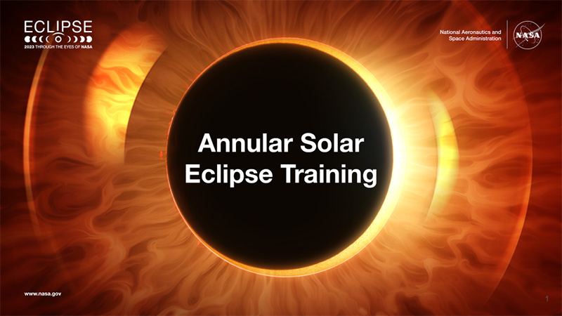 A large black circle representing the Moon covers a bright yellow Sun with flowing fire like orange streamers coming from behind with 'Annular Solar Eclipse Training' spelled out on top of the Moon