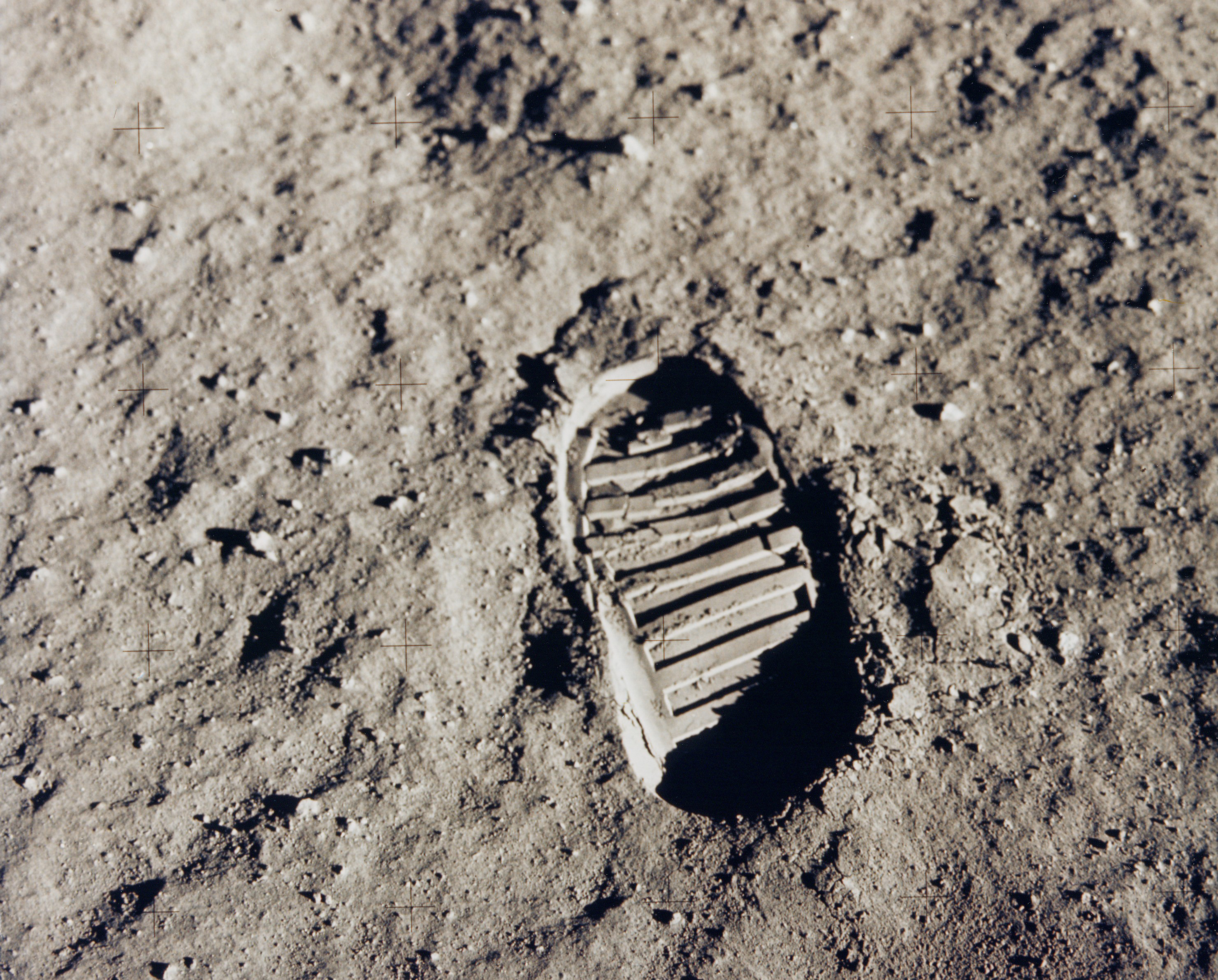Imprint of astronaut boot in a thick layer of powdery, light grey dust.