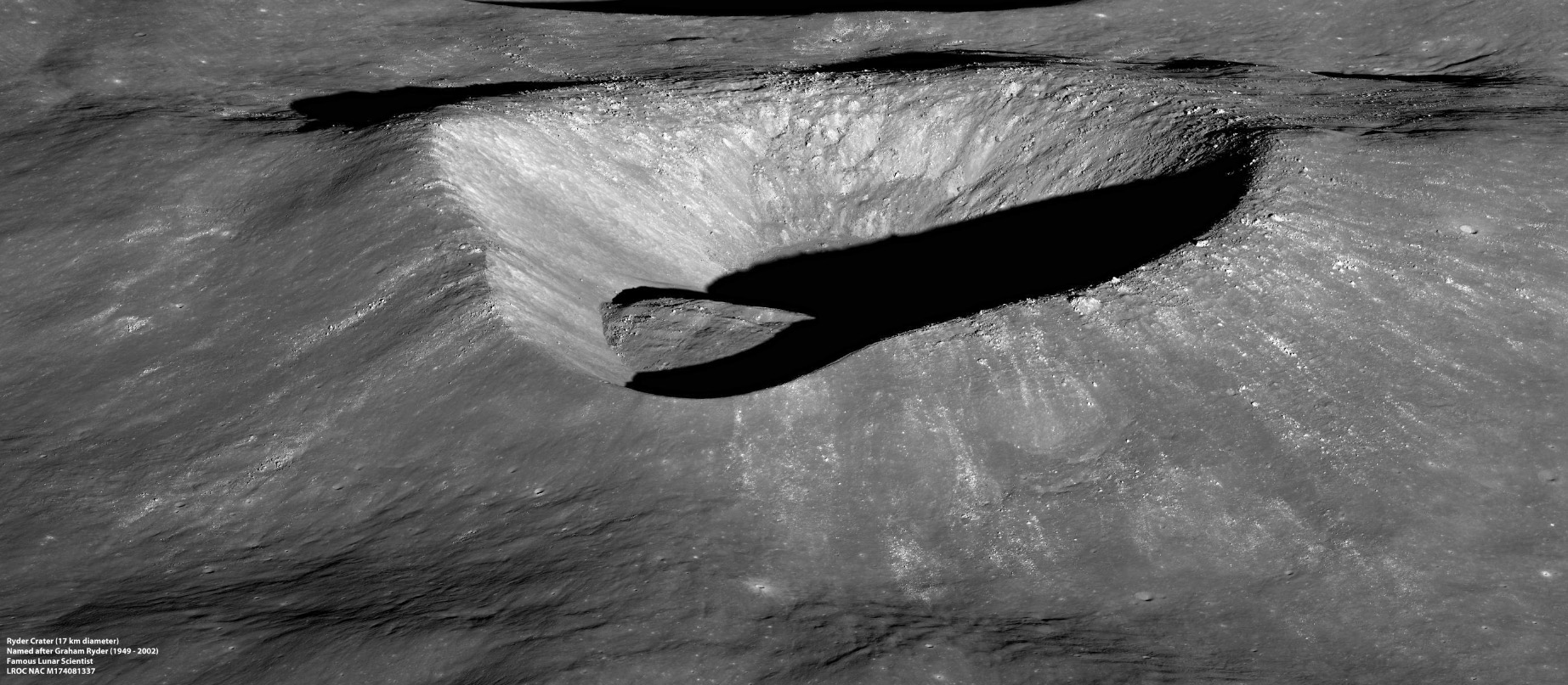 Oblique view of a crater shaped like a rounded triangle, with its edge casting a dramatic shadow inside.