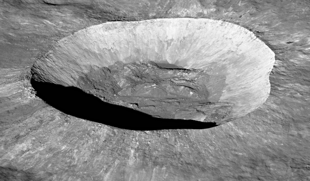 sharply-defined crater, with rocky floor, on the Moon