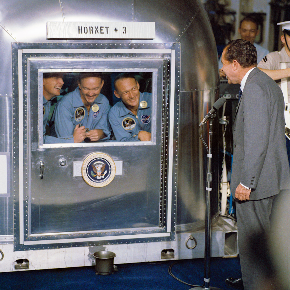Richard Nixon greeting the three Apollo 11 astronauts through a vehicle window