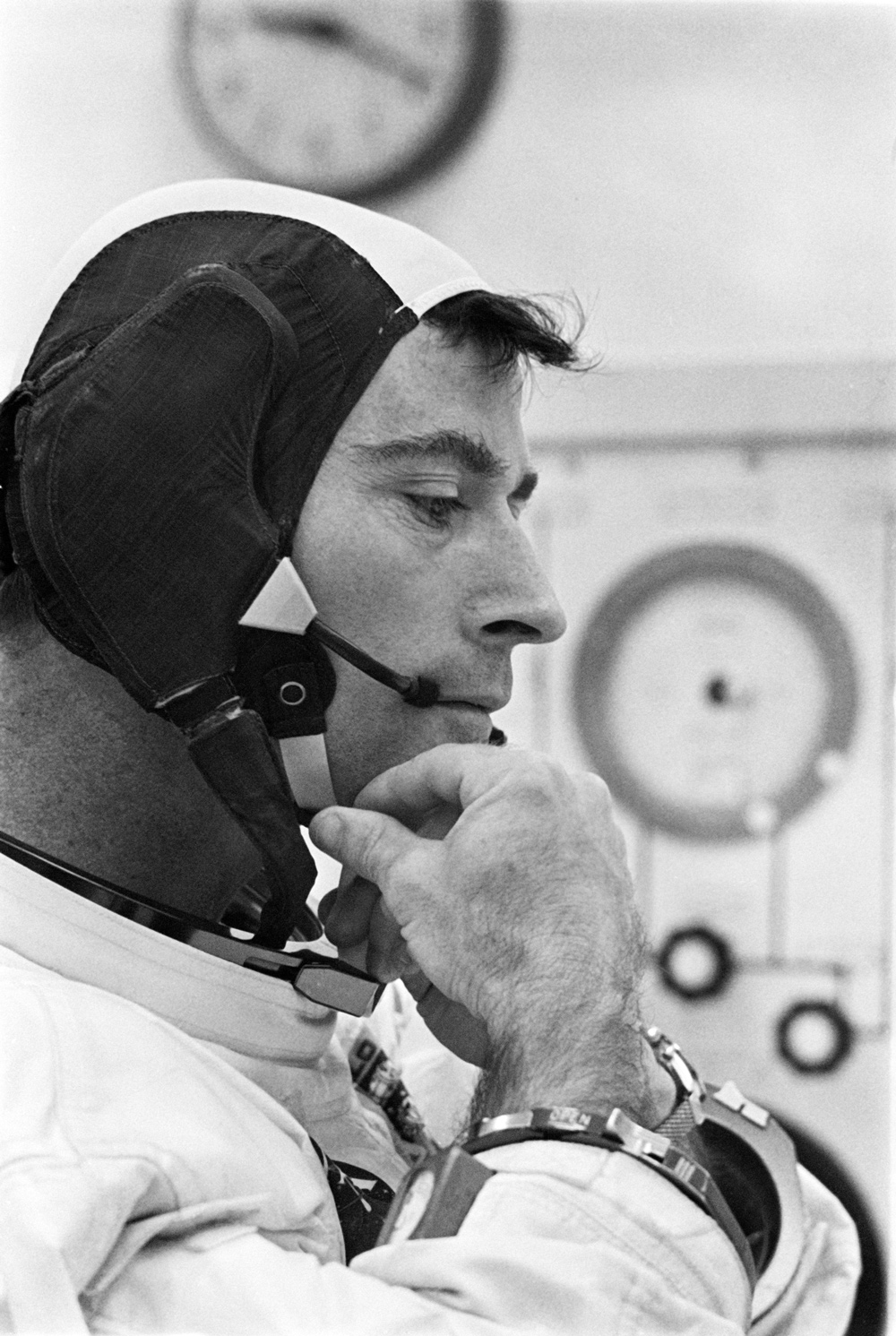 Astronaut adjusting chin strap on his cap