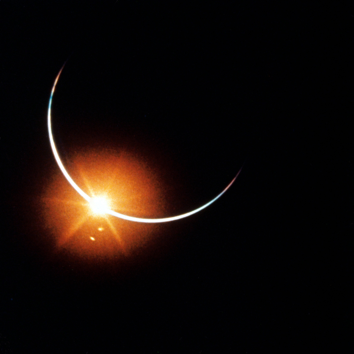 Sun eclipsed by the Earth. Only a sliver of a crescent is visible, with a single point glowing large and bright like the jewel on a ring.