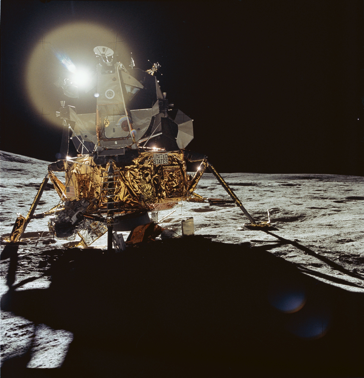 Lunar module on the moon, backlit, casting a deep shadow towards the viewer