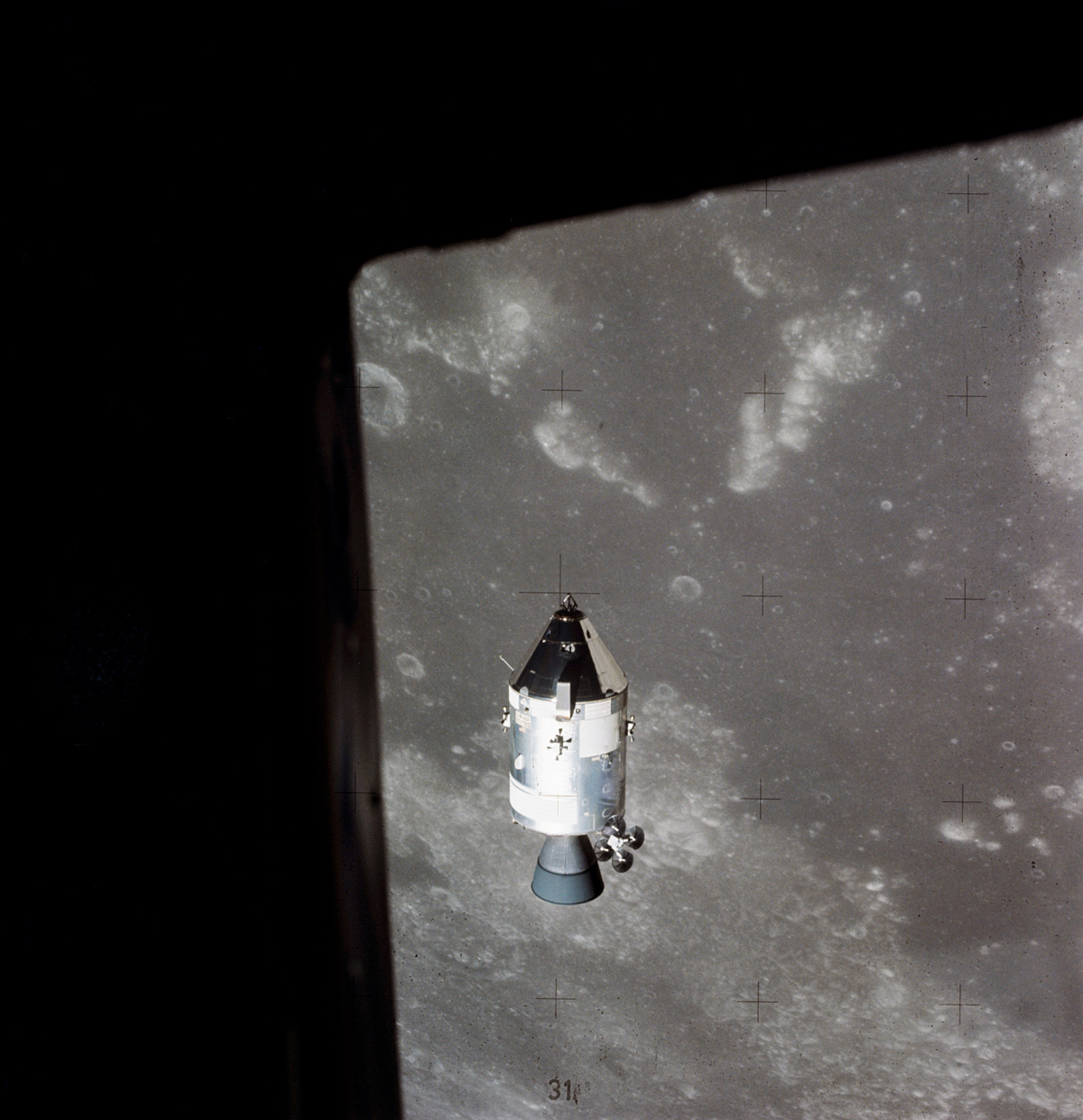 Apollo 15 in lunar orbit, with the surface of the Moon visible in the background. 