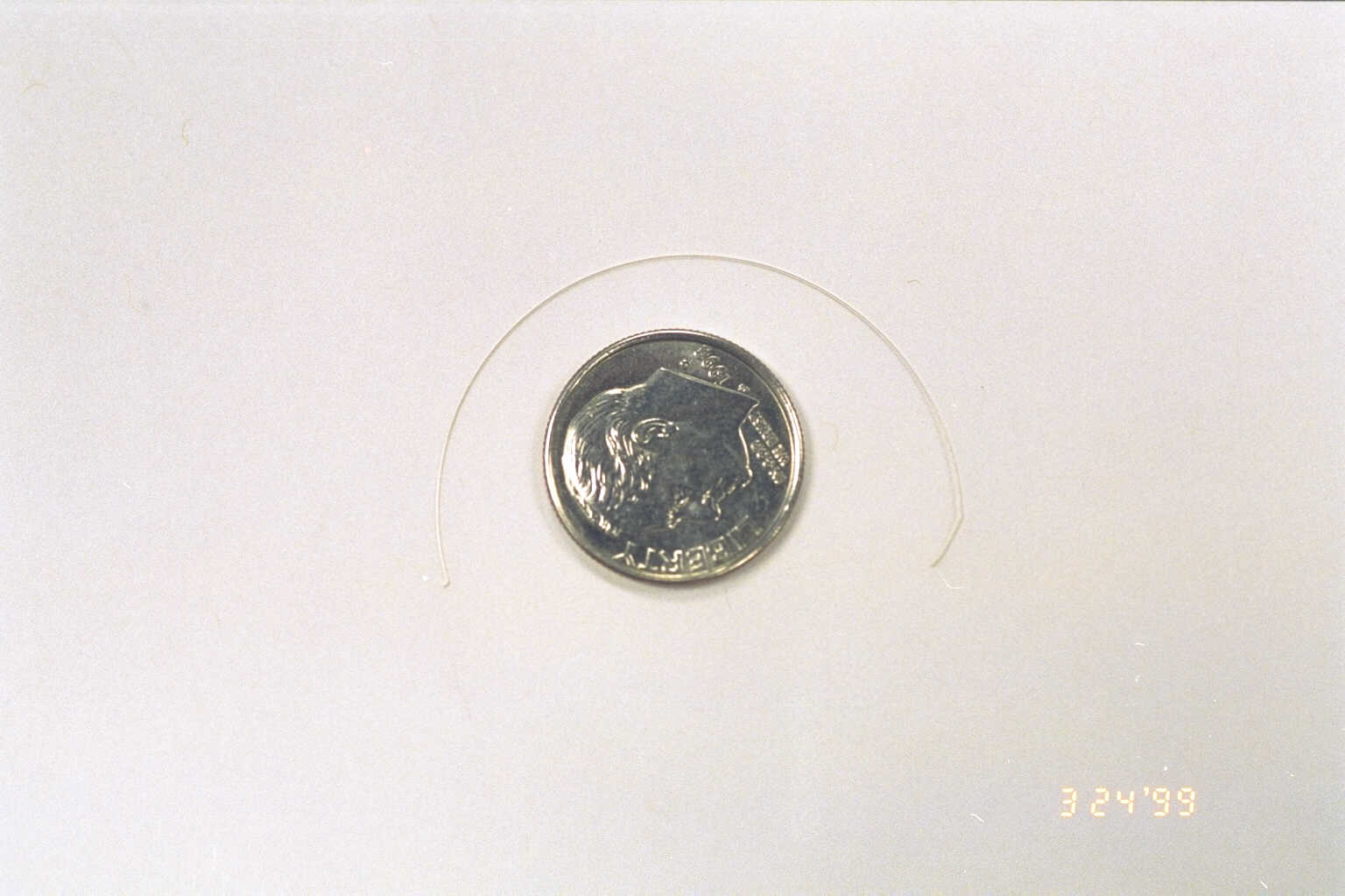 A hair-thin wire laying above a dime