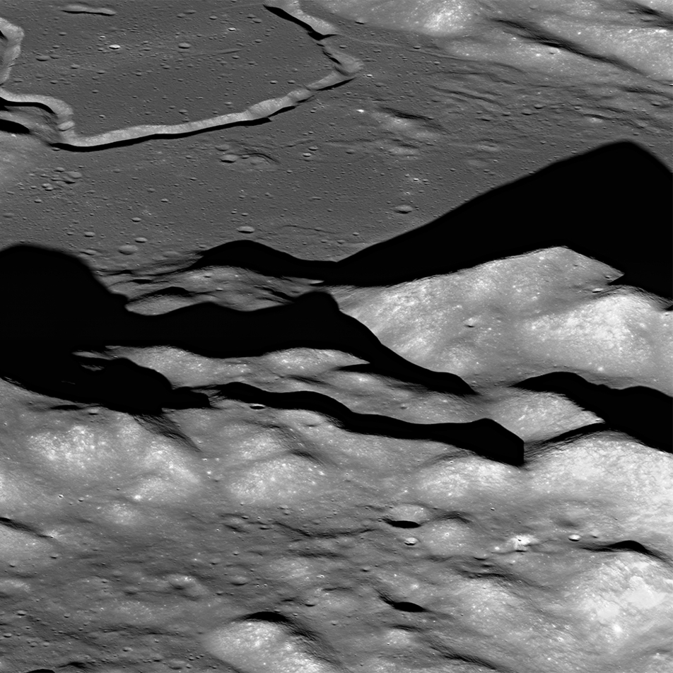 hills and valleys on the lunar surface, with a looping trench in the background