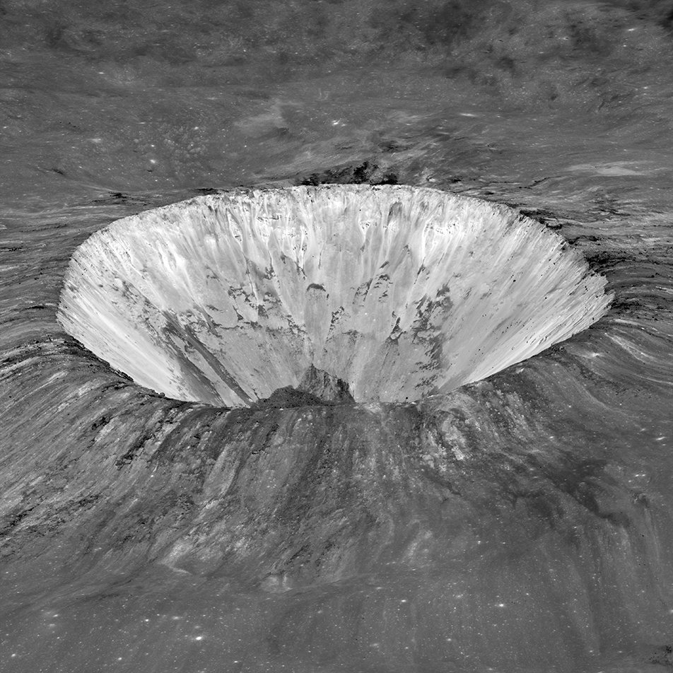 view of round, deep lunar crater, with light-colored, radially streaked inner wall