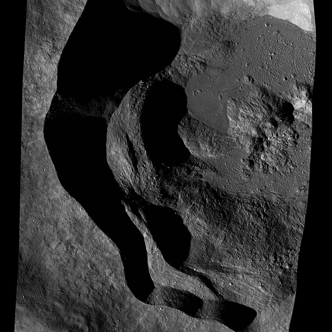 Crater with sharp, sinuous edge and deep shadows.