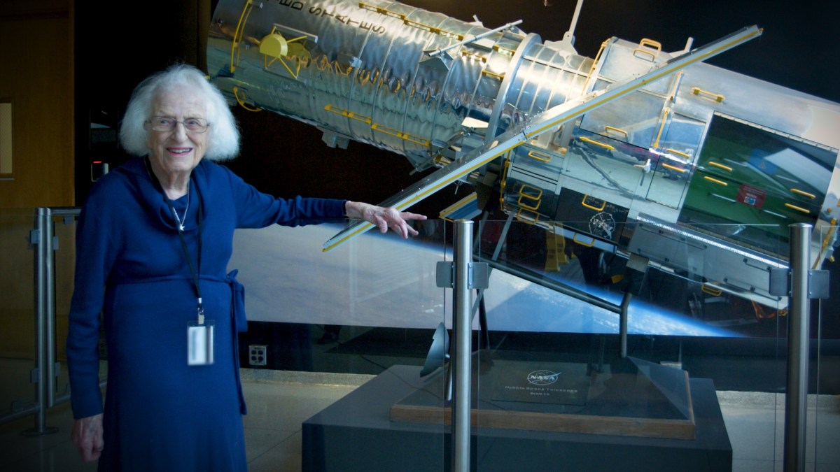 Nancy Grace stands next to a scale model of the Hubble