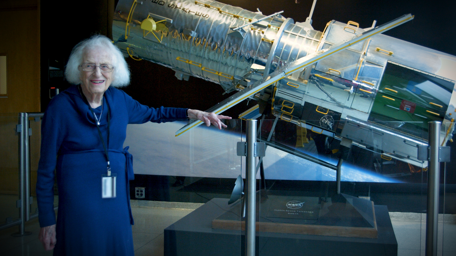 Nancy Grace Roman stands next to a 1/5 scale model of the Hubble Space Telescope