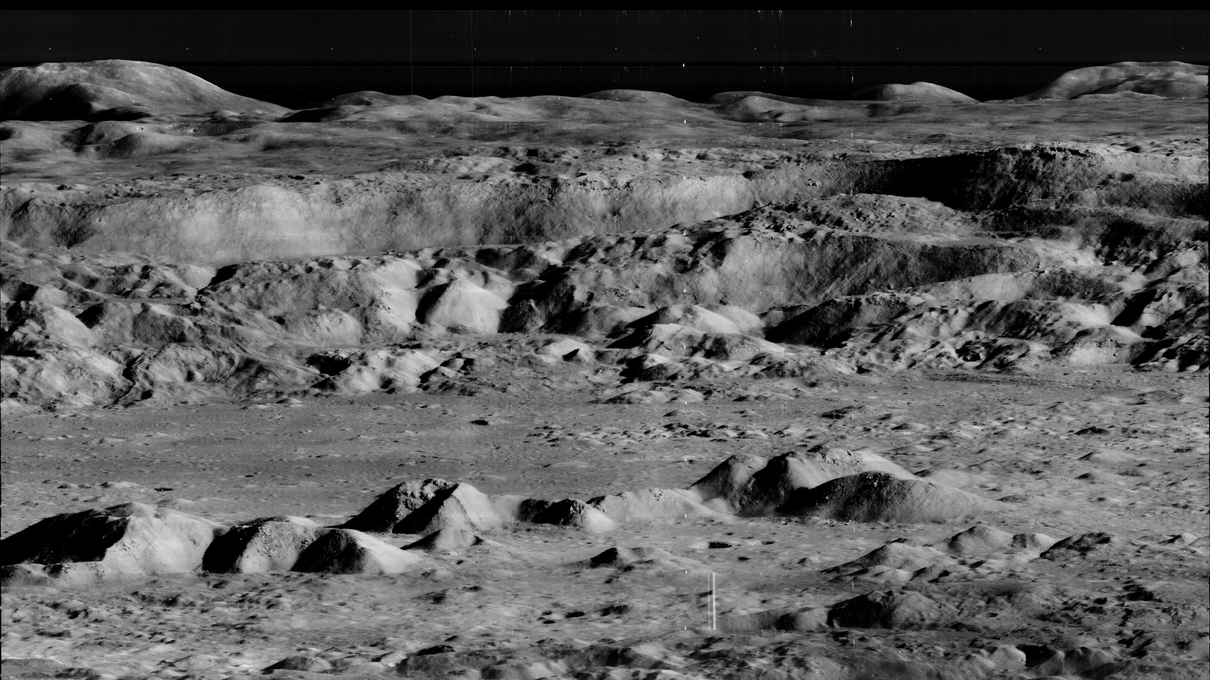 An overhead view of Copernicus crater shows ridges and cliffs extended to a dark horizon.
