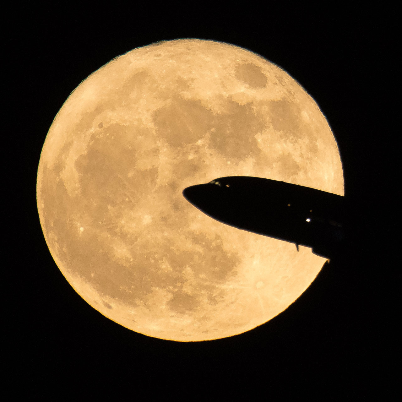 Airline silhouette in front of the Moon.