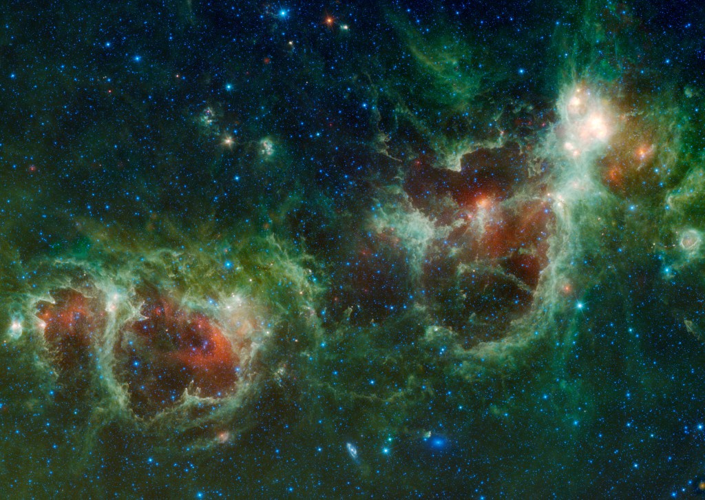 Against a backdrop of very dark blue dotted with hundreds of points of light of varied size, brightness. and shades of cyan, four nebulous blobs – colored in shades of deep maroon and reddish orange – dominate the frame in a curved line extending from the lower left corner to the upper right corner. The two smaller blobs are nearest the corners, while the larger ones dominate the center, all of them with green streamers and jets and tendrils emanating from them, in shades ranging from deep blue-green to olive to light mint. The scene looks like an overhead view of four squished tomatoes hurled into a bioluminescent pool, with the water splashing up and out from the impact changing from blue to green as it shoots out.