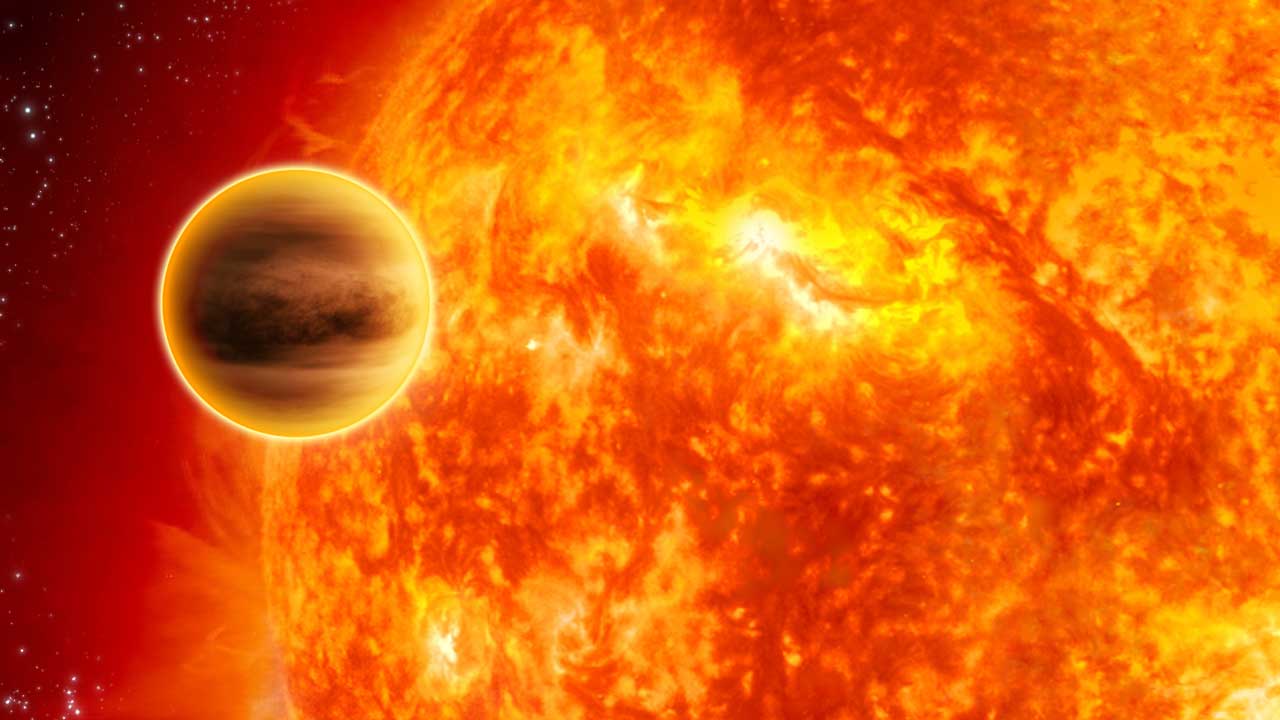 A large planet is seen close to a fiery star like our sun.