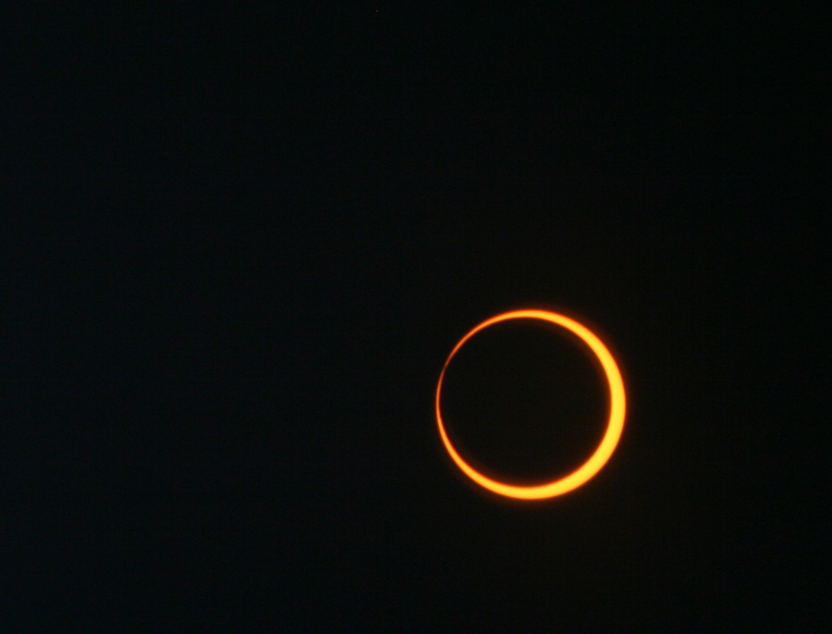 An annular eclipse, shown as an orange ring against a black background
