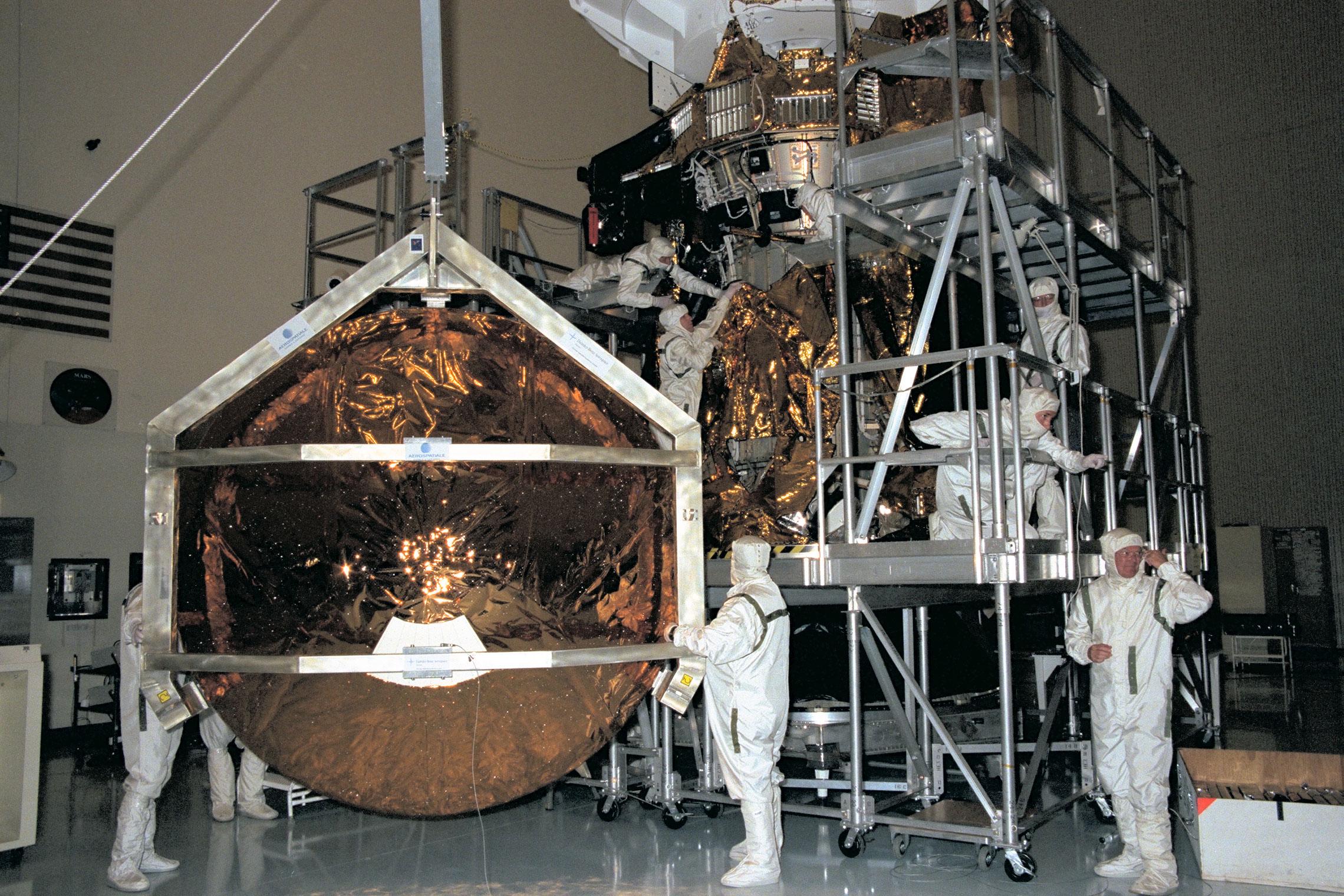 Engineers working on two spacecraft