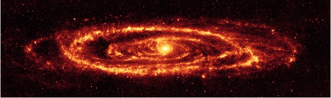 A molten-red ring of light surrounds the bright center of the M31 galaxy. Swirls of smaller yellow and red tendrils encircle the bright central spot, which is just slightly off-center.