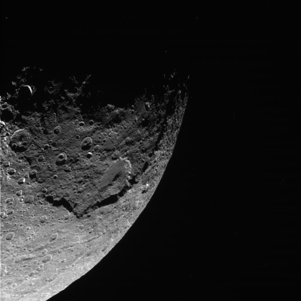 Black and white image showing a massive crater on Iapetus.