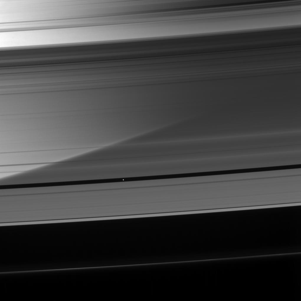 Saturn is visible through the A ring as Pan coasts along its private corridor