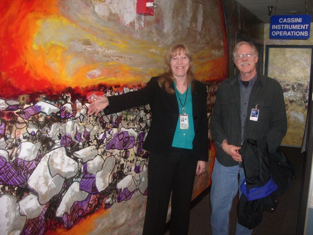 Linda Spilker, Cassini deputy project scientist, and Jeff Cuzzi, Saturn ring specialist, stand in front of a section of the mural