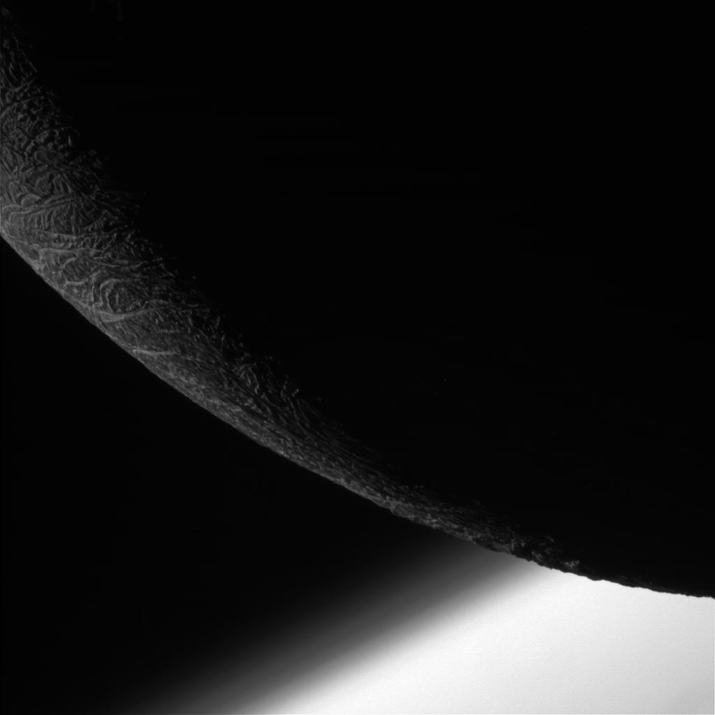 Enceladus, with Saturn in the background