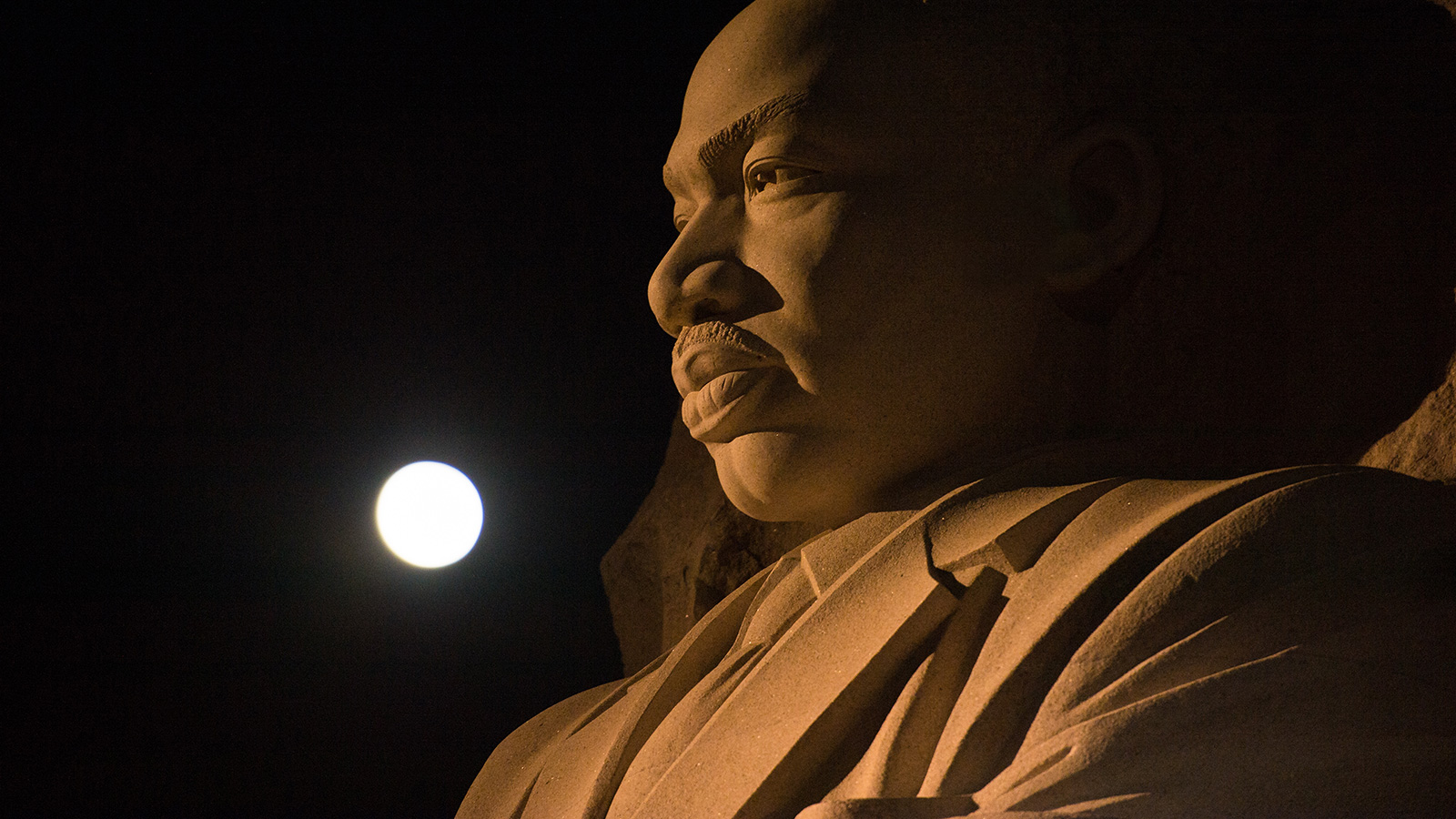 Full Moon over giant statue of the Martin Luther King Jr.