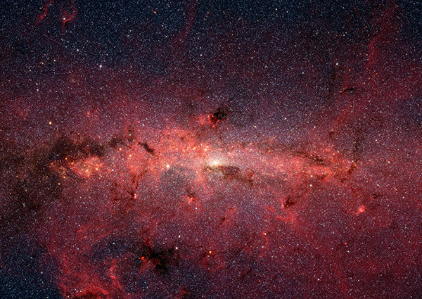 The center of our Milky Way galaxy is hidden from the prying eyes of optical telescopes by clouds of obscuring dust and gas. But in this stunning vista, NASA's Spitzer Space Telescope's infrared cameras penetrate much of the dust, revealing the stars of the crowded galactic center region.